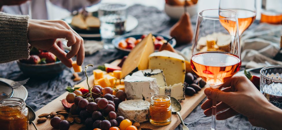 people drinking wine and eating cheese